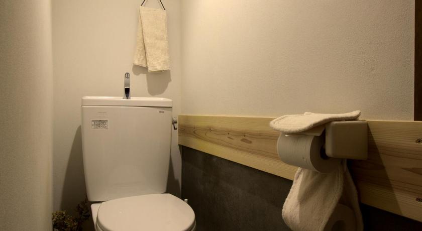a white toilet sitting next to a bathroom sink, Izumo guesthouse itoan in Izumo