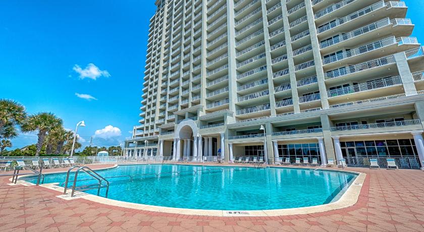 a large swimming pool in front of a large building, Ariel Dunes II in Destin (FL)