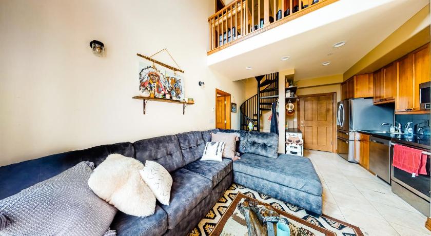 a living room filled with furniture and a fire place, LOGE Breckenridge in Breckenridge (CO)