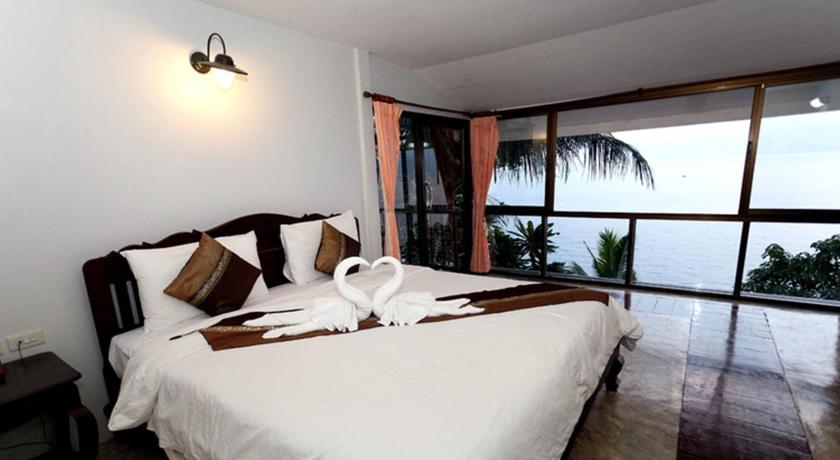 a bedroom with a large bed and a large window, Chang Cliff Resort (SHA Extra Plus) in Koh Chang