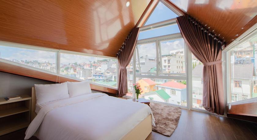 a bedroom with a bed and a window, Nang Chieu Hotel Đa Lat in Dalat