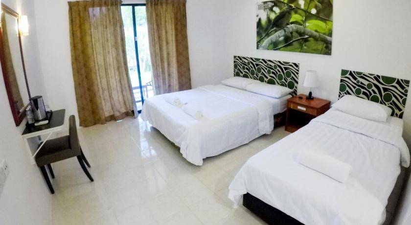 a hotel room with two beds and two lamps, Xcape Resort at Taman Negara in Kuala Tahan
