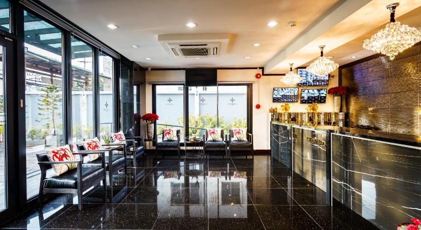 a living room filled with furniture and a large window, Lux Boutique Hotel in Nonthaburi