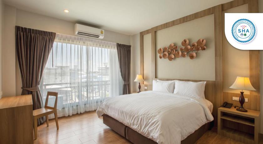 a bedroom with a large bed and a large window, Civilize Hotel (SHA Extra Plus) in Udon Thani