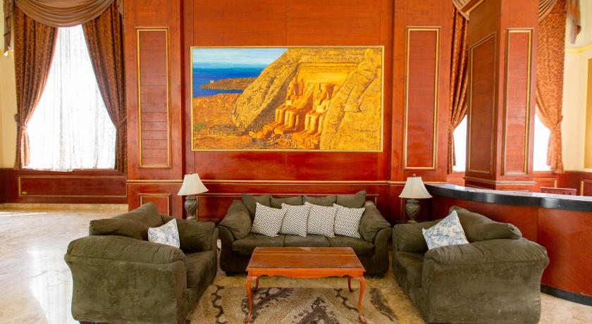 a living room filled with furniture and a painting on the wall, Grand Pyramids Hotel in Giza