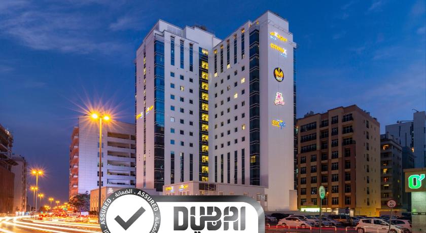 a large building with a clock on the side of it, Citymax Hotel Al Barsha at the Mall in Dubai