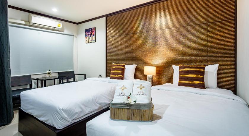 a hotel room with two beds and two lamps, Lux Boutique Hotel in Nonthaburi