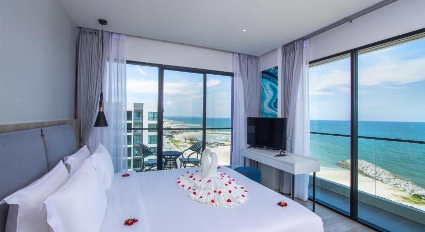 a hotel room with a balcony overlooking the ocean, Fortune Saeng Chan Beach Hotel Rayong (SHA Certified) in Rayong