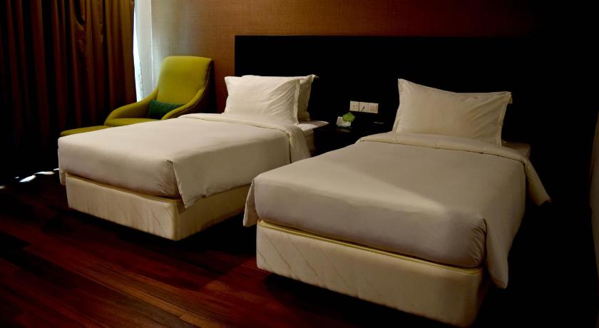 a hotel room with two beds and two lamps, Lazenda Hotel in Labuan