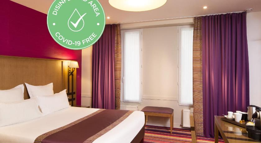a hotel room with a large bed and a large window, Hotel Mondial in Paris