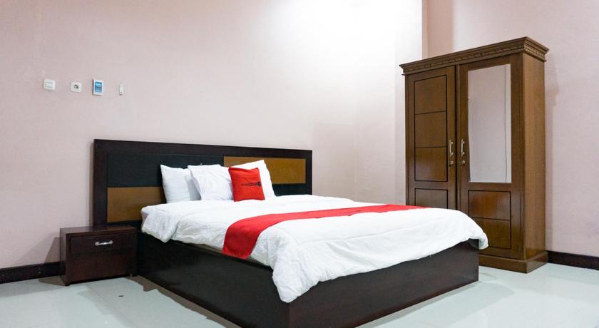 a bedroom with a bed and a dresser, RedDoorz @ Jalan Cendrawasih Timika in Timika