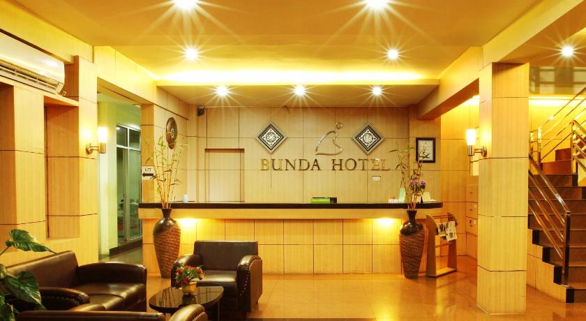 a large room with a large clock on the wall, Bunda Hotel in Padang