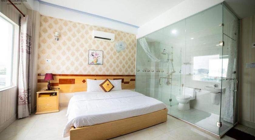 a hotel room with a bed and a shower, Yen Vy 04 Luxury hotel in Quy Nhon (Binh Dinh)