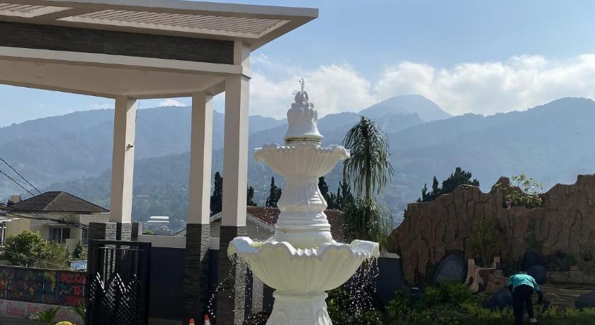 a statue of a man standing in front of a fountain, Marseillia Hills in Puncak