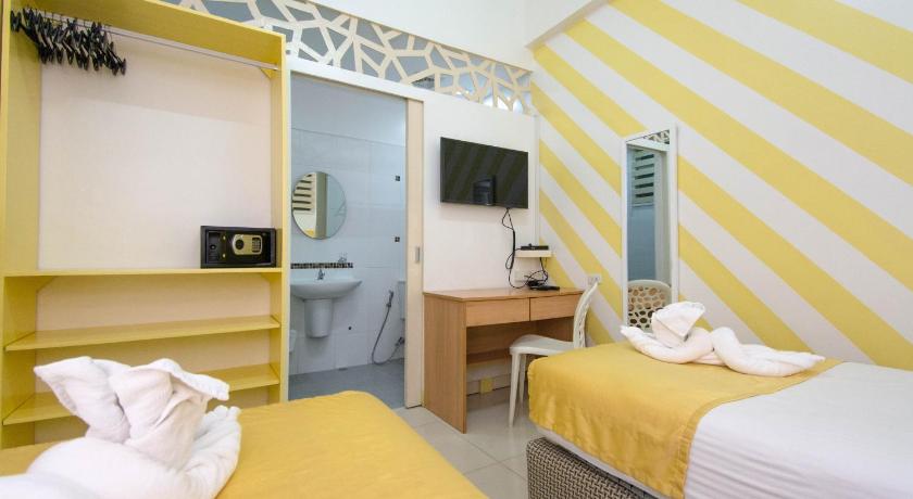 a bedroom with a bed and a desk, Alicia Residences in Cebu