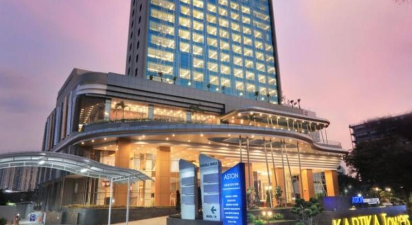 a large building with a clock on the front of it, Aston Kartika Grogol Hotel & Conference Center in Jakarta