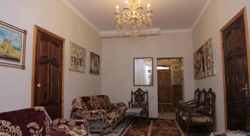 a living room filled with furniture and a painting on the wall, Rumi in Bukhoro