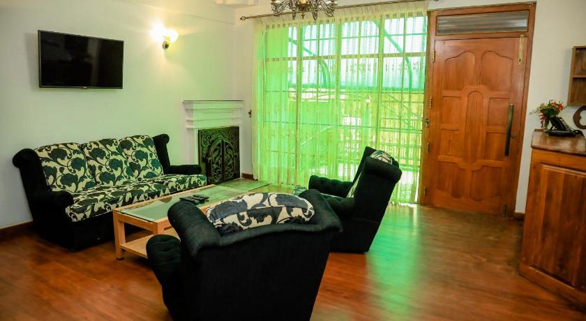 a living room filled with furniture and a window, Bungalow By Camellia in Nuwara Eliya