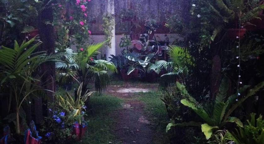 a garden area with plants and a fence, SHUKRAN Apartelle in Siquijor Island
