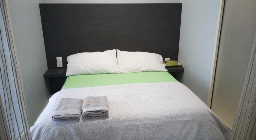 a bed with white sheets and a white comforter, Urban 360 Studio Love Rara Suite Homestay in Kuala Lumpur
