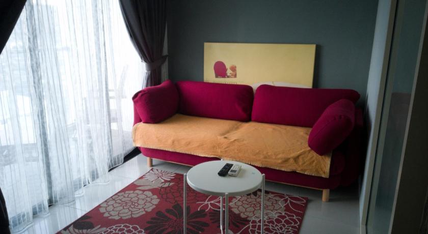 a living room with a red couch and a red chair, Urban 360 Studio Love Rara Suite Homestay in Kuala Lumpur