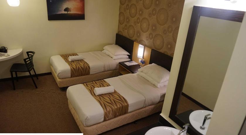 a hotel room with two beds and a television, Regalo Hotel Kota Laksamana in Malacca