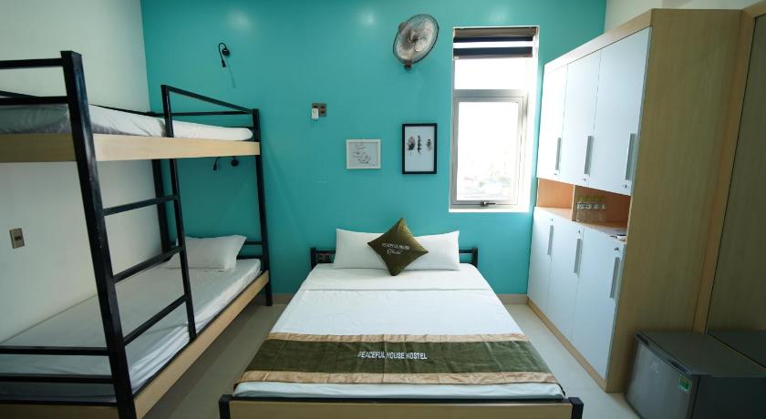 a bedroom with a bed and a desk, Peaceful House Hostel in Dong Hoi (Quang Binh)