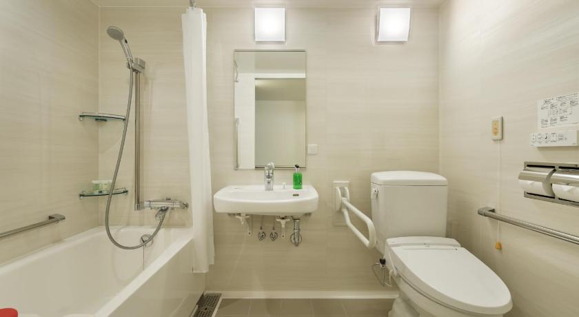 a bathroom with a toilet a sink and a bathtub, Fairfield by Marriott Sapporo in Sapporo