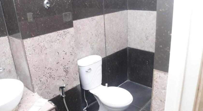 a white toilet sitting in a bathroom next to a wall, RedDoorz near Colgante Bridge Naga City in Naga City