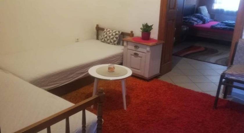 a room with a bed and a table in it, Passion Apartment in Pecs