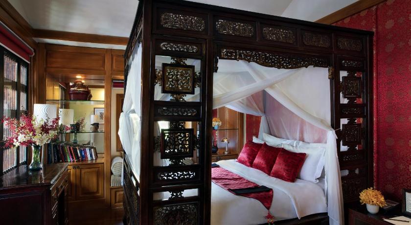 a bedroom with a large bed and a large window, Chakrabongse Villas (SHA Plus+) in Bangkok