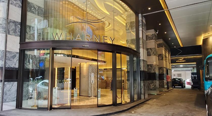 a large building with a large mirror on the side of it, Wharney Hotel in Hong Kong