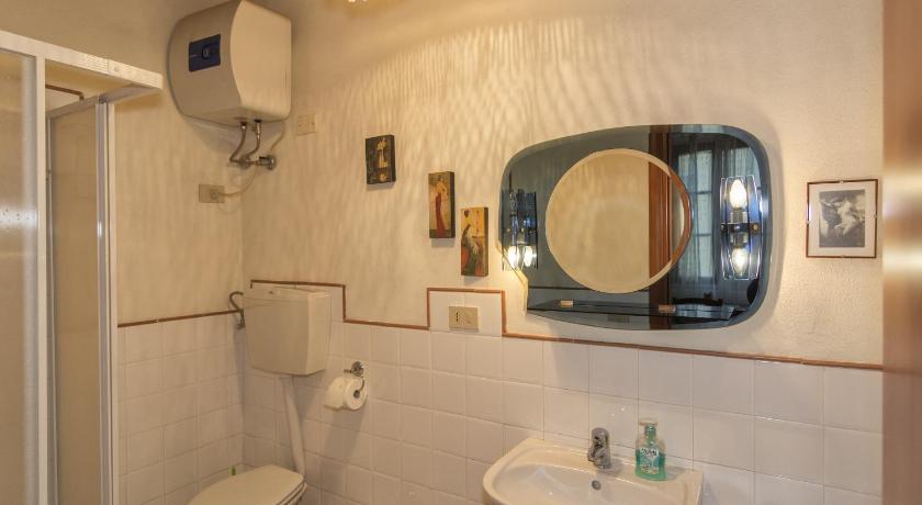 a bathroom with a toilet a sink and a mirror, B&B Due Borghi in Pisa