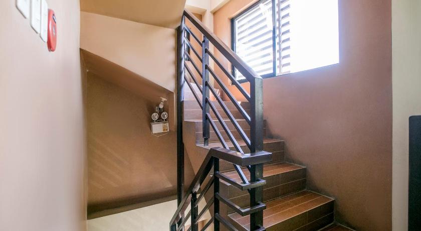 a stairway leading up to a room with a window, Rjat Guesthouse in Laguna
