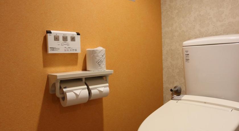 a white toilet sitting next to a wall in a bathroom, Chiba sta 1min J hotel 2020 Open in Chiba