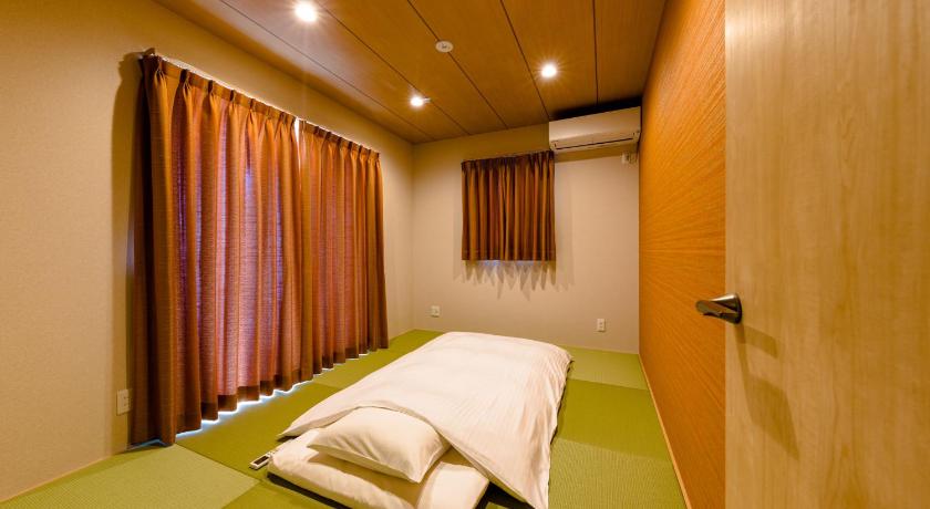 a large bed in a room with a large window, ResortClub 03雅 in Fujikawaguchiko