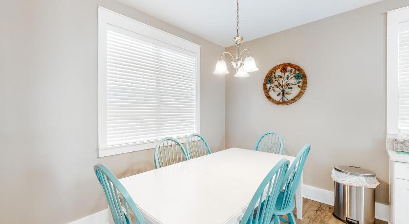 a kitchen with a table and chairs and a window, Barefoot Cottages #B16 in Port Saint Joe