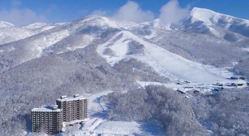 a snow covered mountain with a mountain range, One Niseko Resort Towers in Niseko