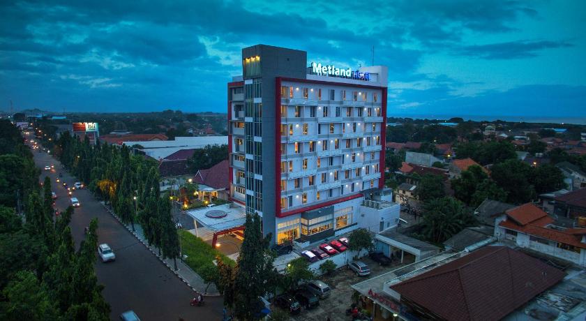 a large building with a clock on top of it, Metland Hotel Cirebon by Horison in Cirebon