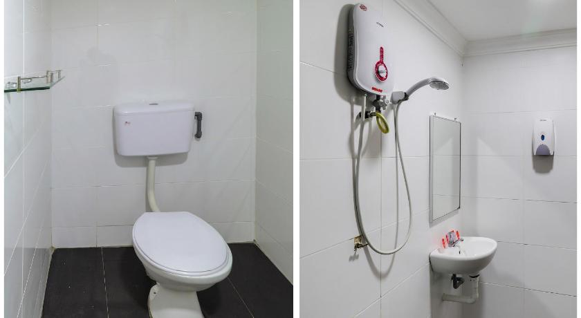 a white toilet sitting next to a white sink, OYO 89473 SP VENTURE HOTEL in Kuala Lumpur