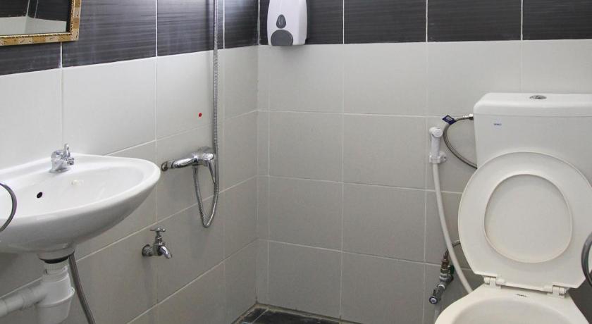 a bathroom with a toilet a sink and a bathtub, Dream City Hotel in Kuching