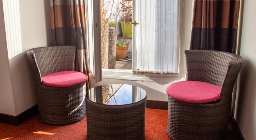 two chairs sitting next to each other in a room, 55 Montparnasse Hotel in Paris