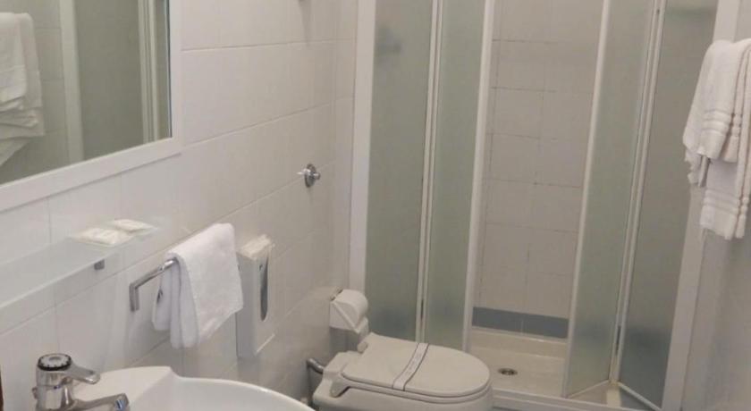a bathroom with a toilet, sink, and shower, Hotel Bellariva in Pescara