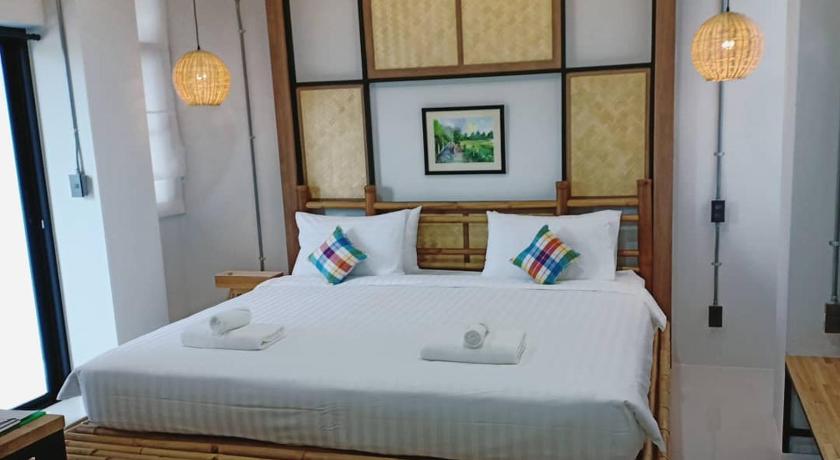 a hotel room with a bed and a dresser, Luck Esan Loft in Ubon Ratchathani
