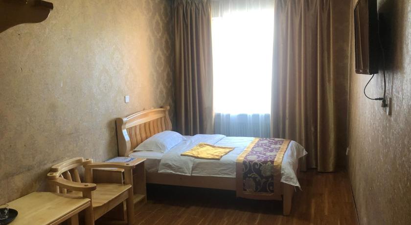 a bedroom with a bed and a window, Land Hotel in Ulaanbaatar