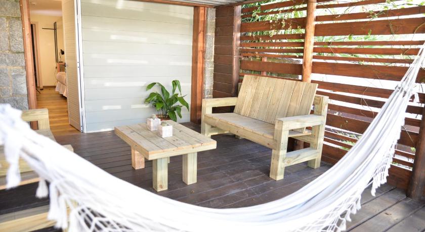 a patio area with chairs, a table, and a patio umbrella, TAS D VIAJE Suites - Hostel Boutique in Punta Del Este