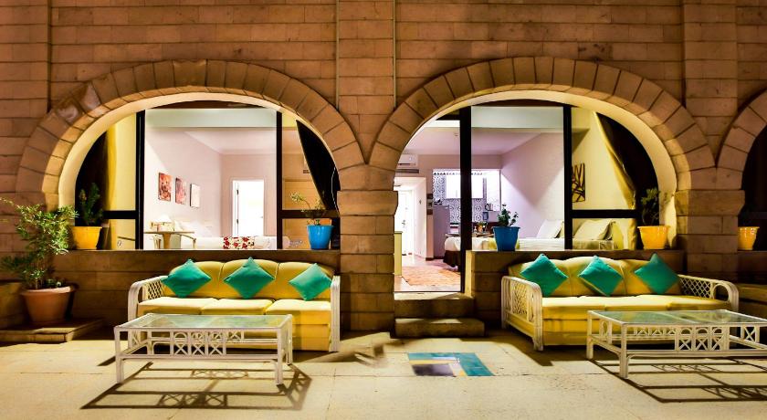 a living room filled with furniture and a large window, Basma Executive Club in Aswan