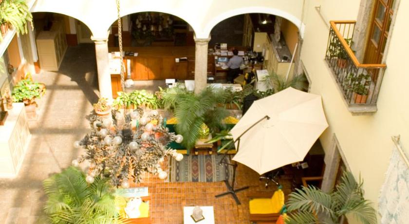 a large outdoor area with a patio area with tables and chairs, Hotel San Francisco Plaza in Guadalajara