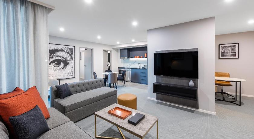 a living room filled with furniture and a tv, DECO HOTEL in Canberra