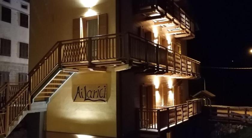 a hotel room with a balcony overlooking the ocean, Ai Larici in Perarolo di Cadore